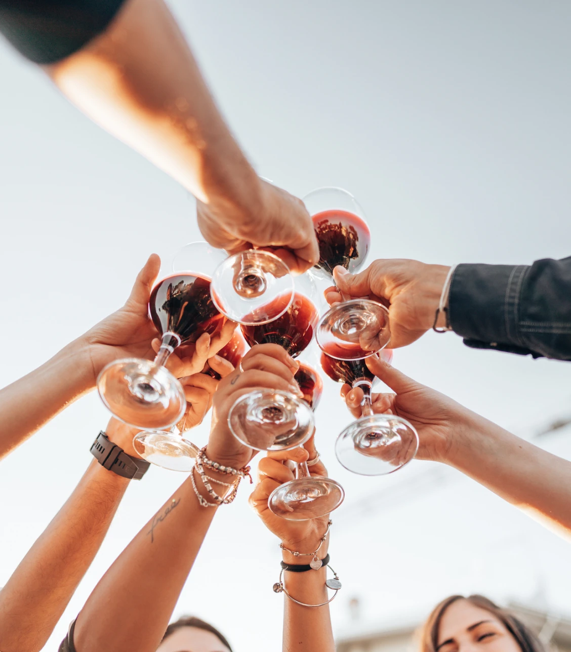 Group celebration with red wine