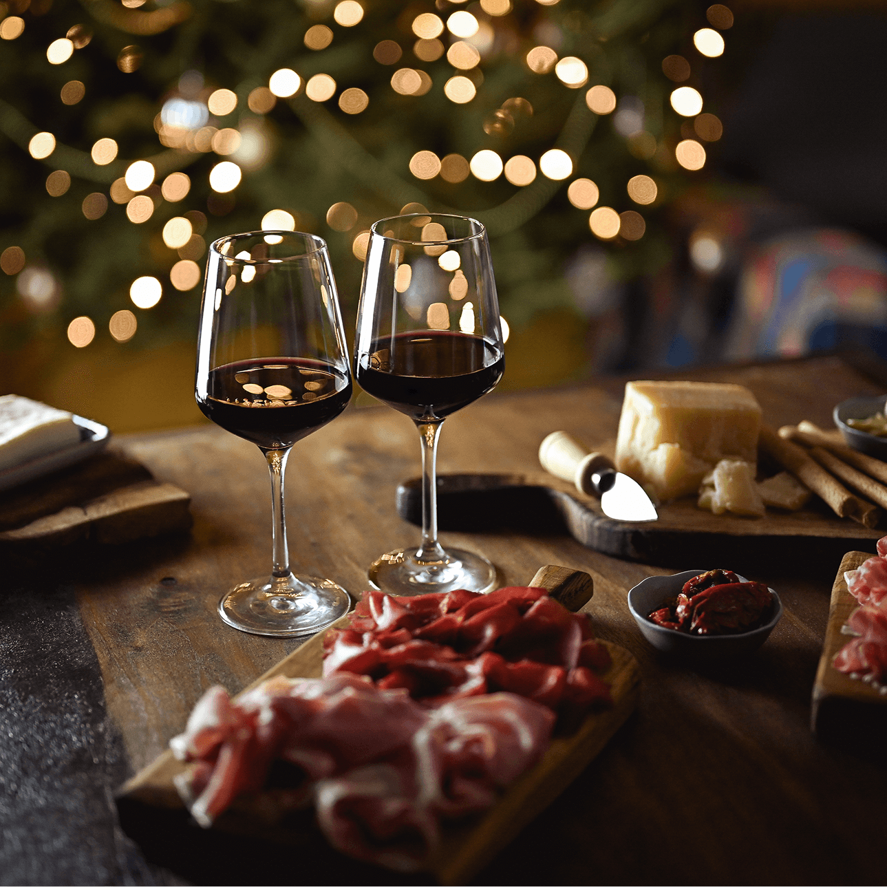 Two wine glasses with charcuterie board
